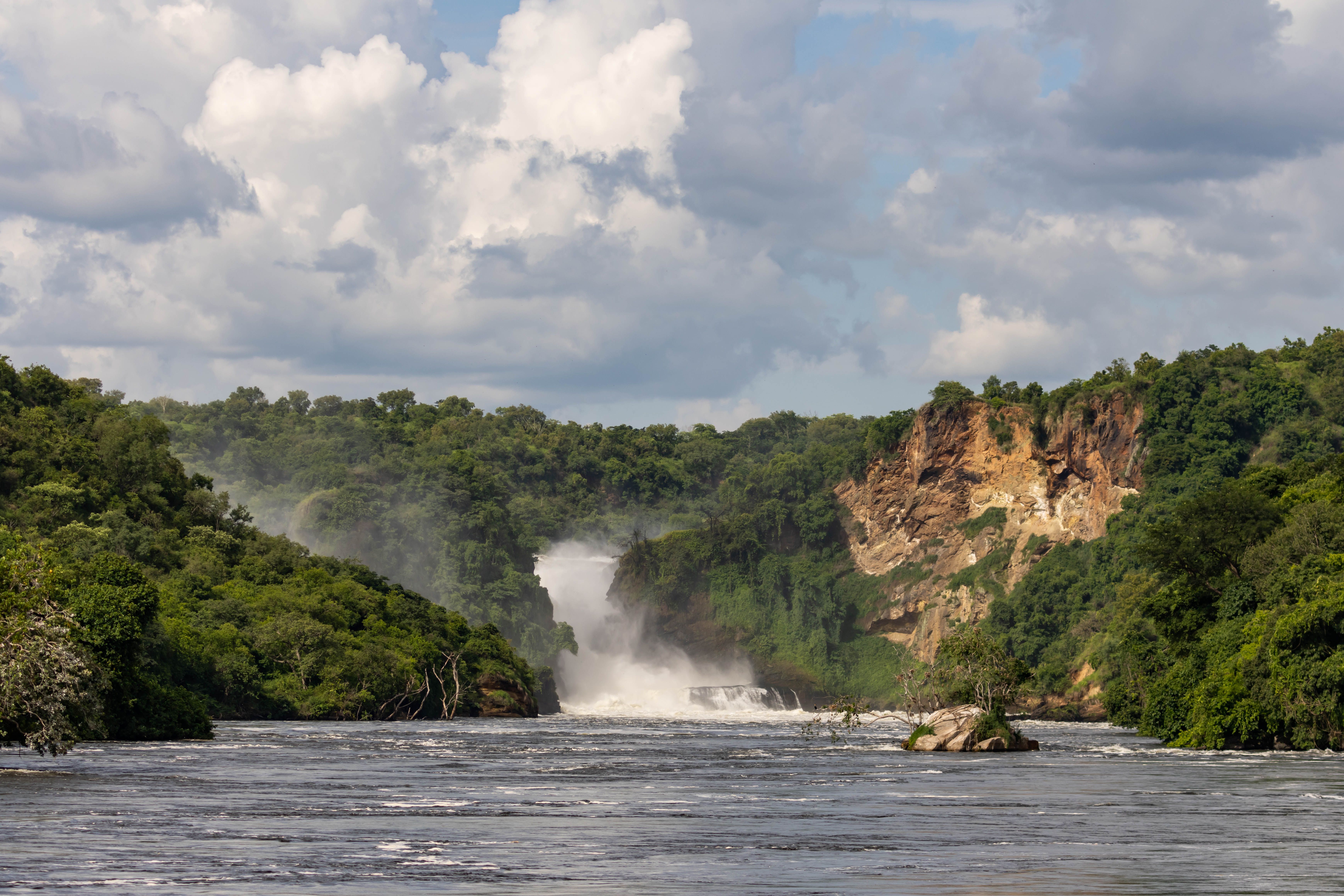 Golden Tanzanian savanna transitioning toward a calm blue coastline